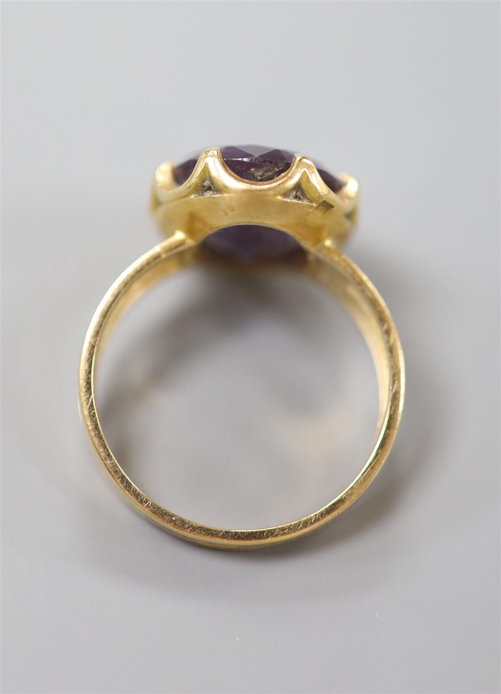 A Middle Eastern yellow metal and synthetic colour change corundum set dress ring, size Q, gross 6.4 grams.